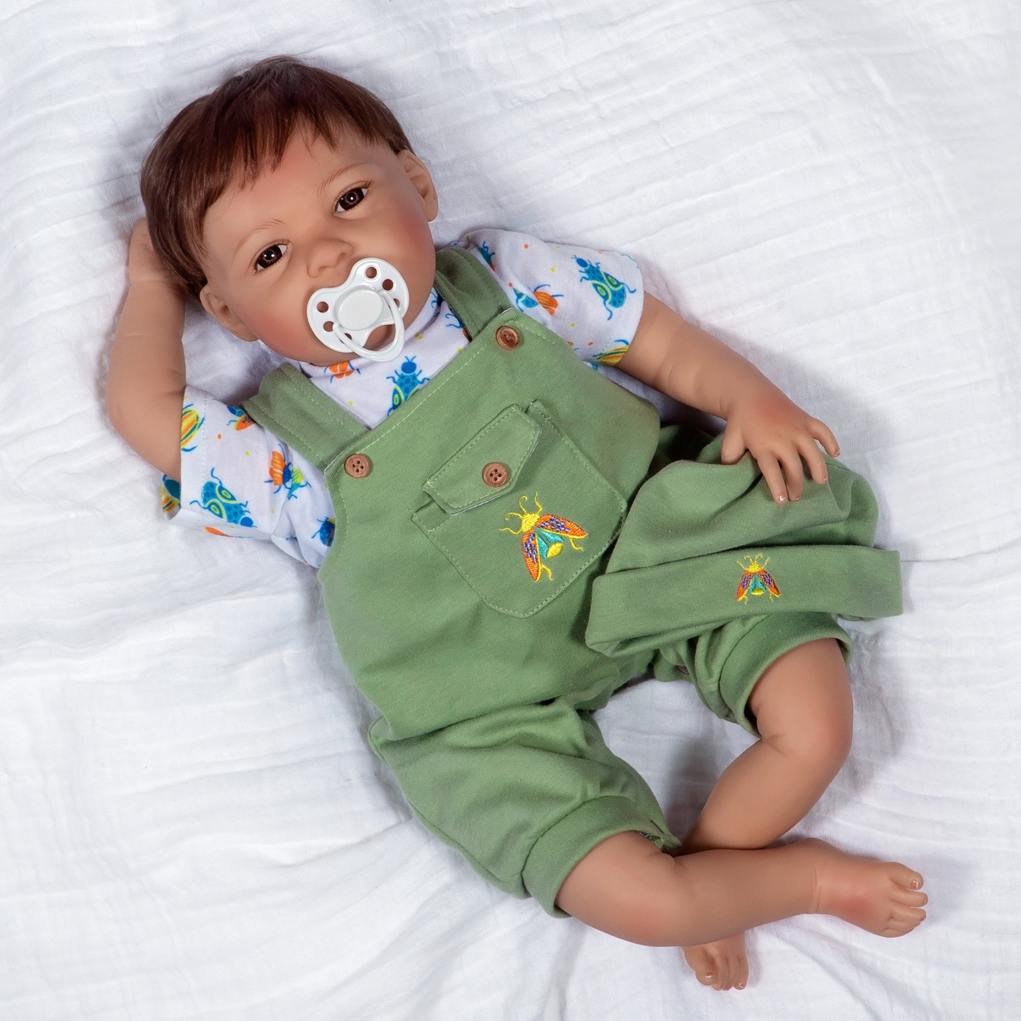 21 inch realistic toddler boy doll sculpted by doll artist Jannie de Lange. Crafted from our GentleTouch™ vinyl that gives that decadently soft and luxurious feel of real, baby-smooth skin, and comes with a weighted cloth body that features a more tapered realistic look and weighted bean bag bottom.